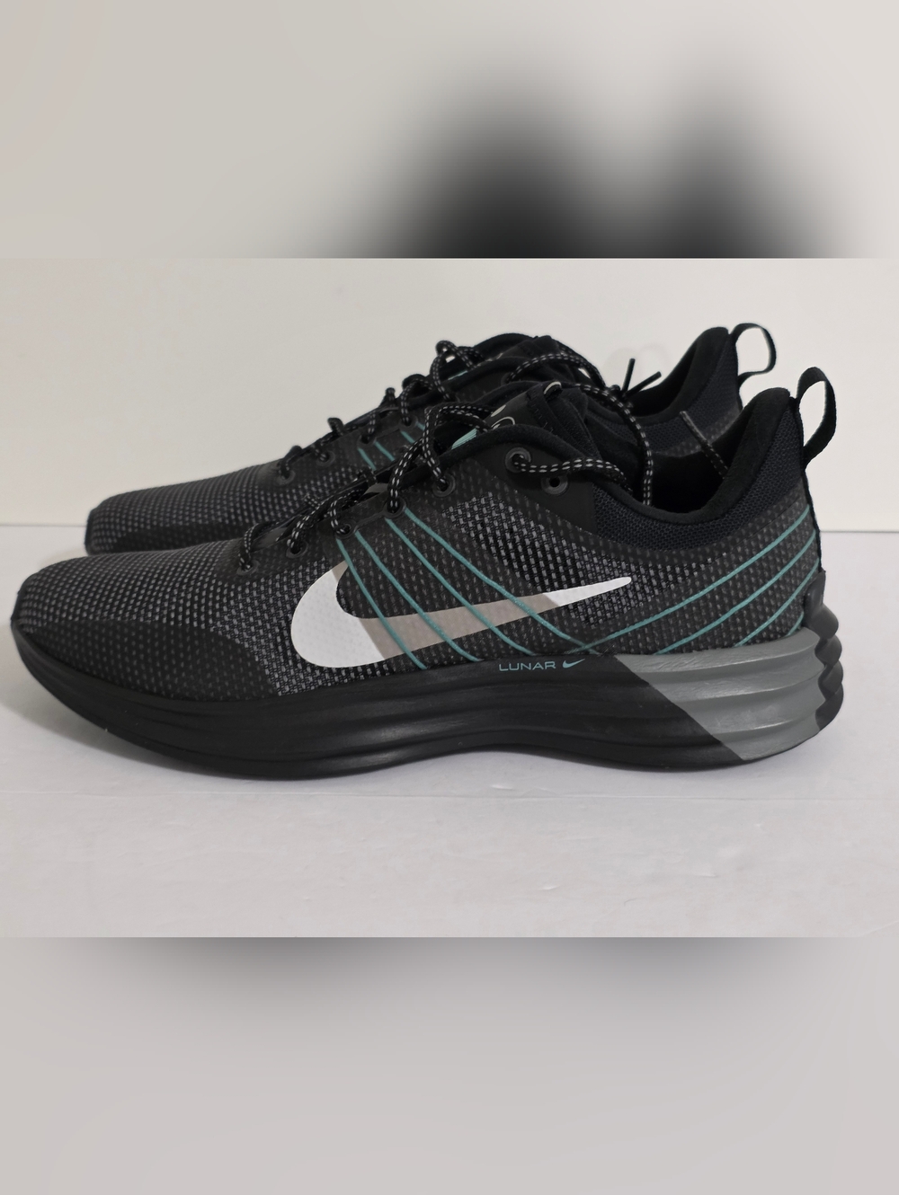 Nike Men’s Black Sneakers with Teal Stripes and White Swoosh